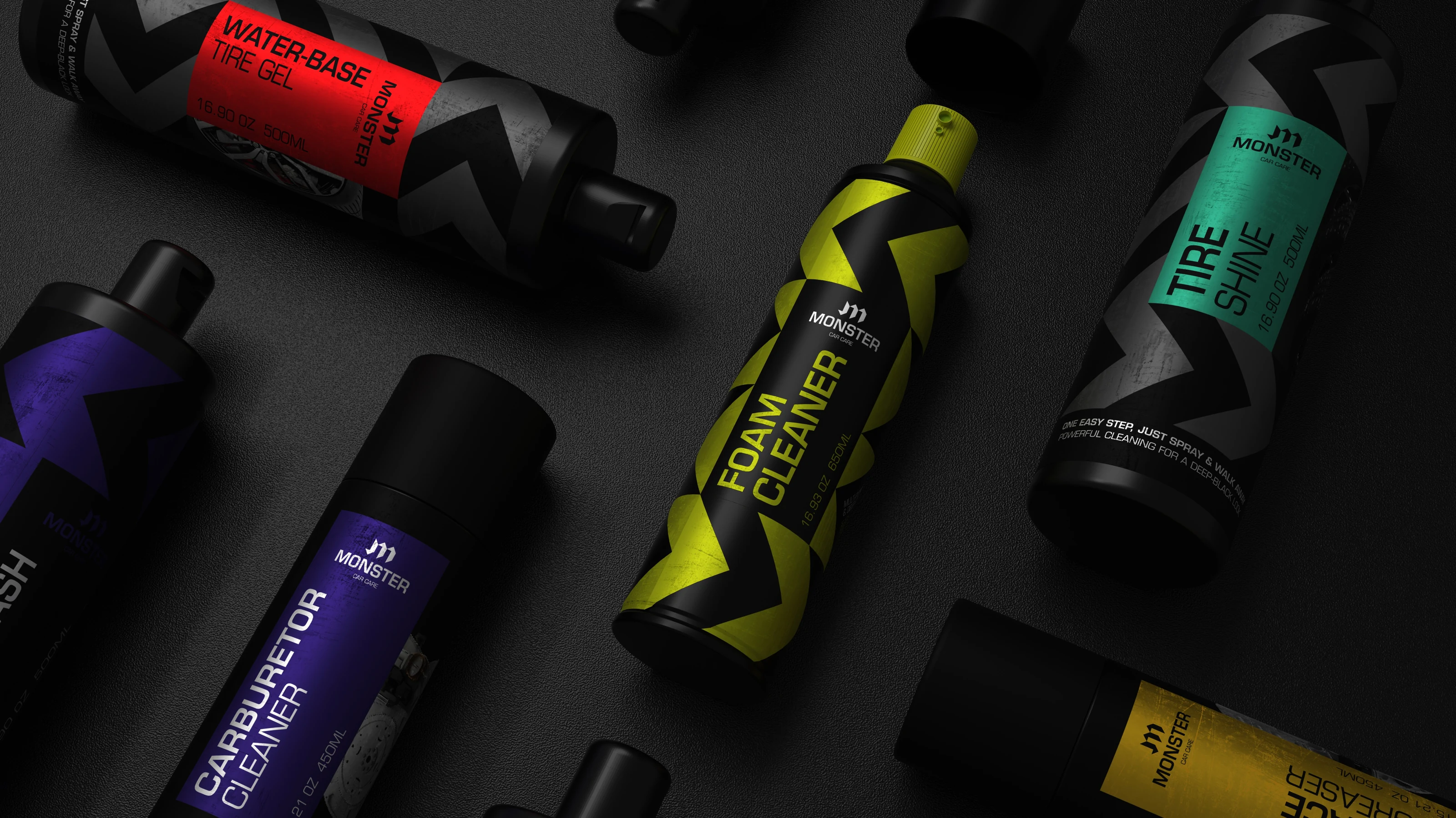 Monster car care products laid out on a dark surface